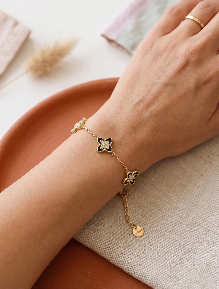 Armband met klavers versierd met witte zirkonia's - Goud/zwart